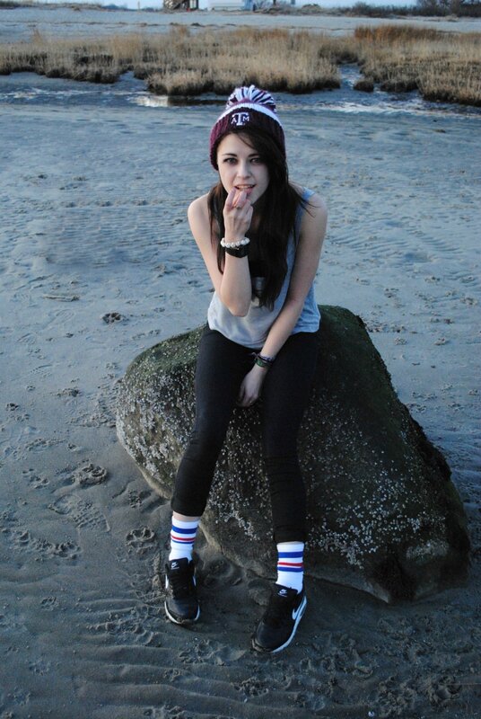 Girl sitting on a rock at the beach
