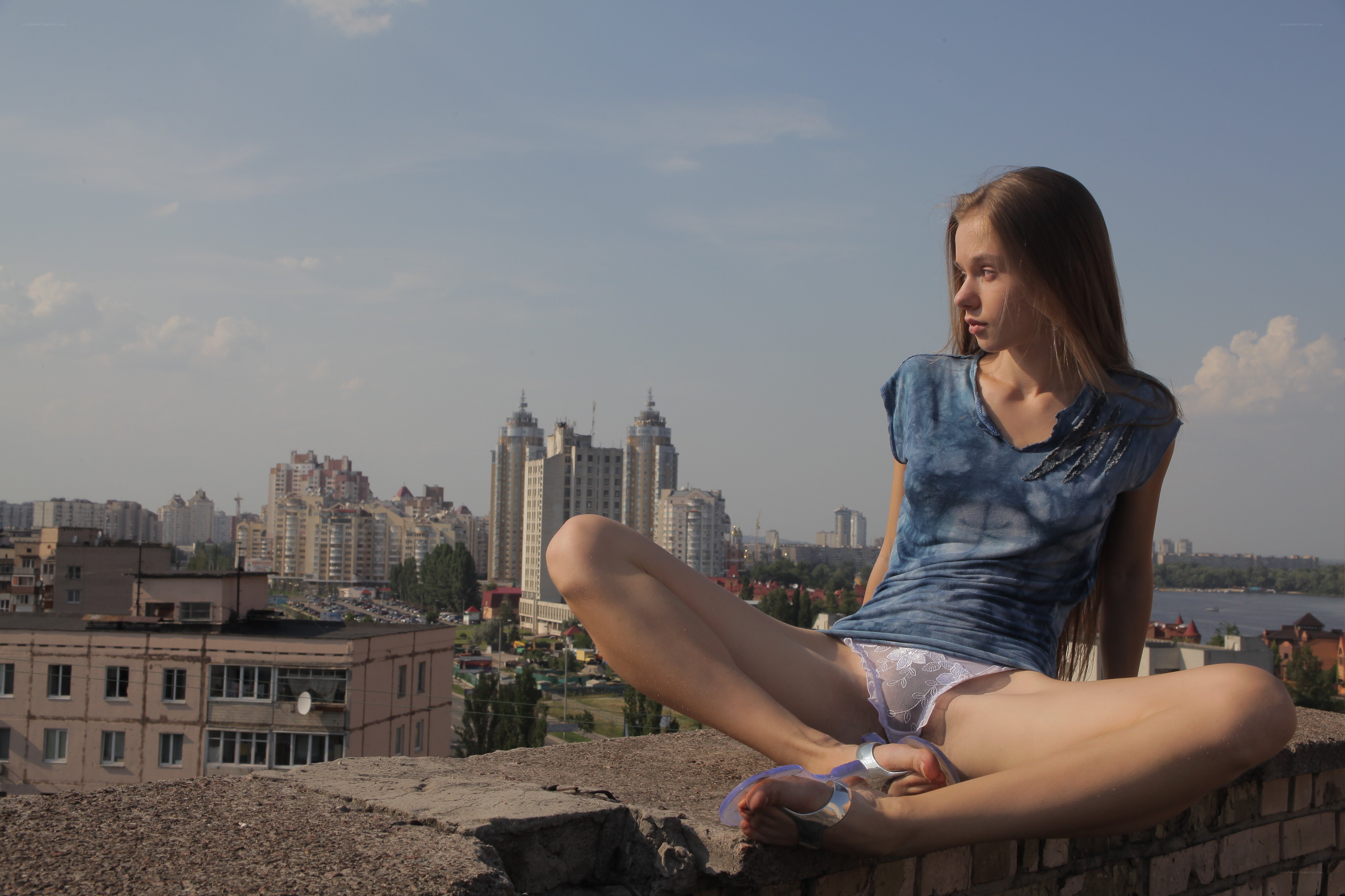 Girl sitting on a rooftop