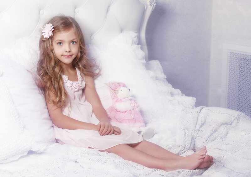 Girl Sitting on Bed — White, Serene