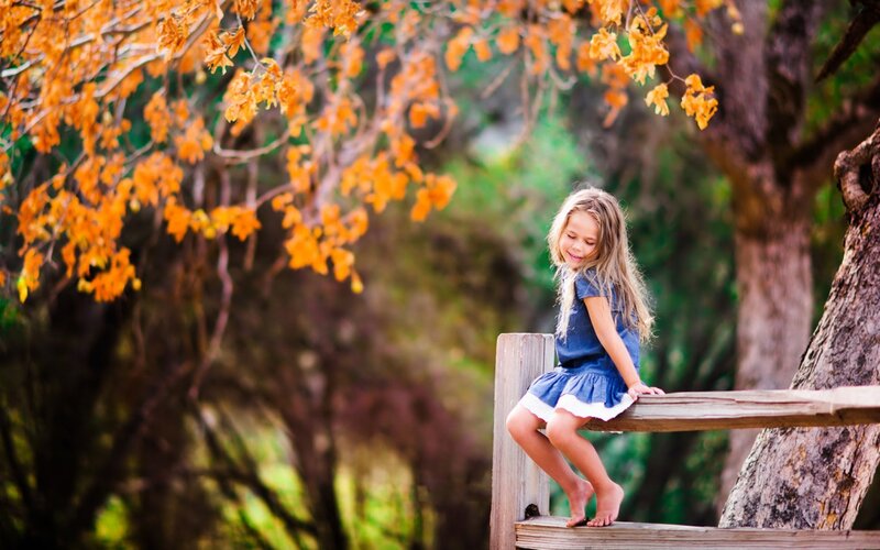 Girl Sitting on Bench — Orange