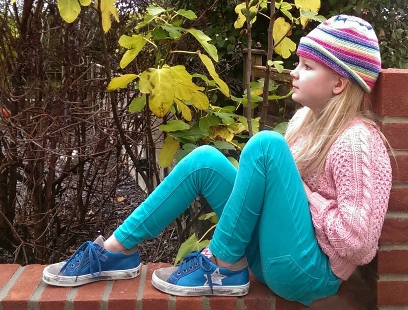 Girl Sitting on Brick Wall