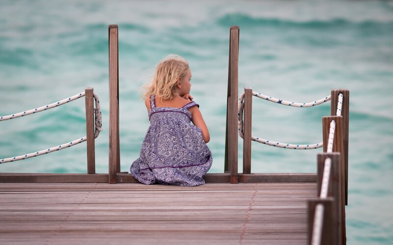 Girl Sitting on Dock — Blue, Calm