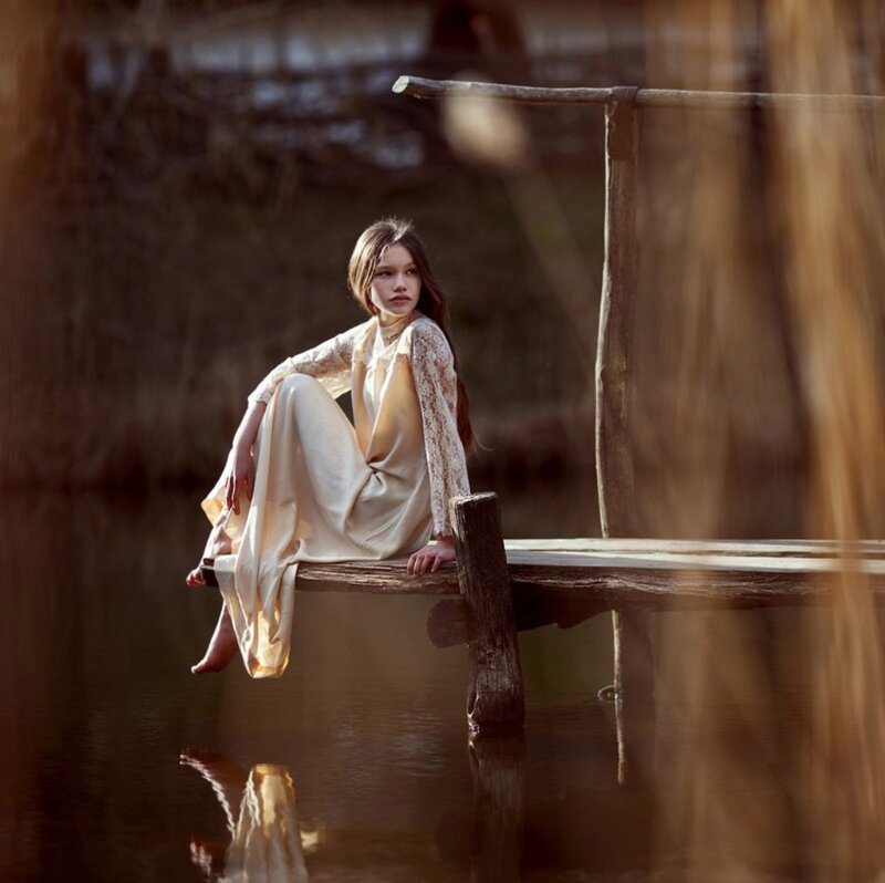 Girl Sitting on Dock — Brown