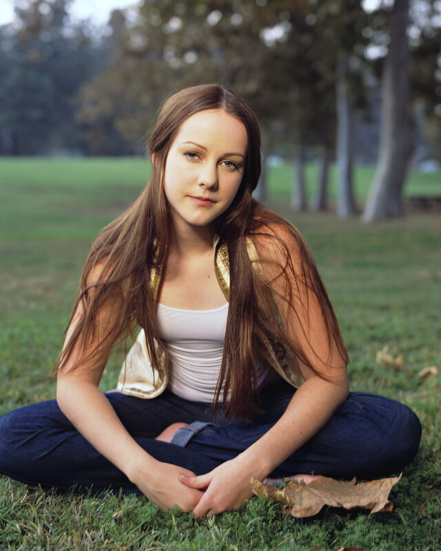 girl sitting on grass in park