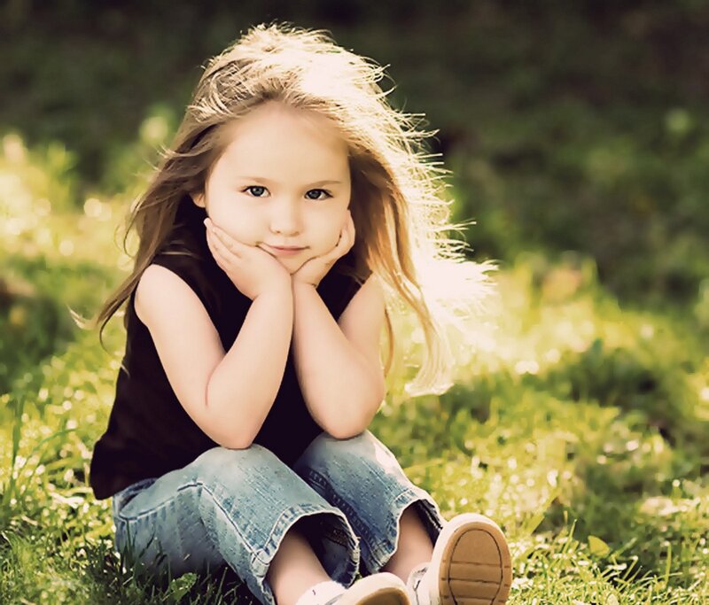 girl sitting on grass outdoors