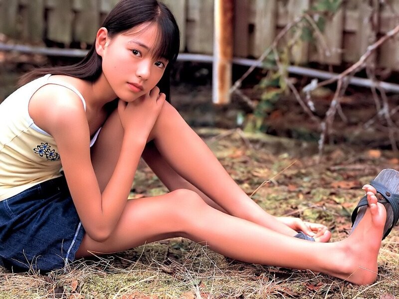 girl sitting on grass outdoors