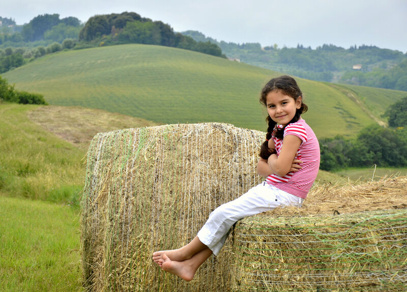 Girl Sitting on Hay Bale — Green