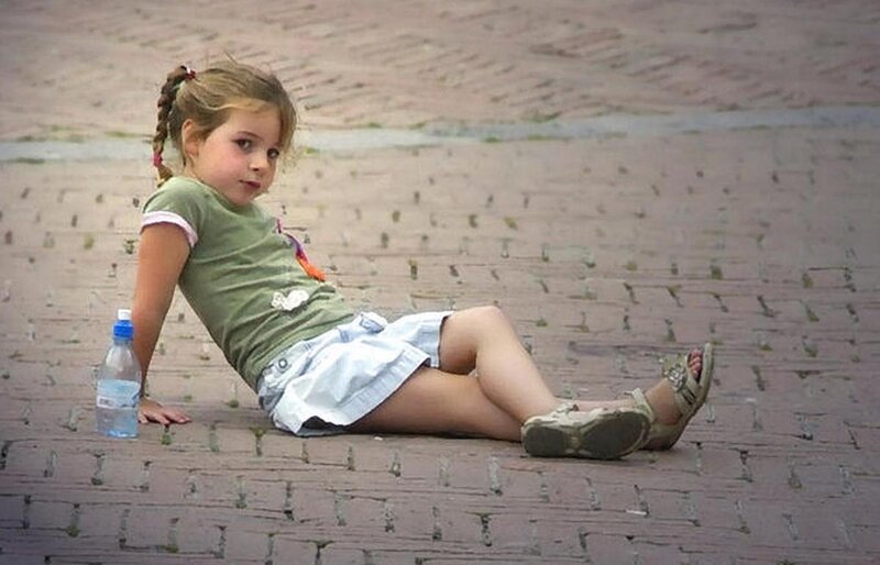 girl sitting on pavement