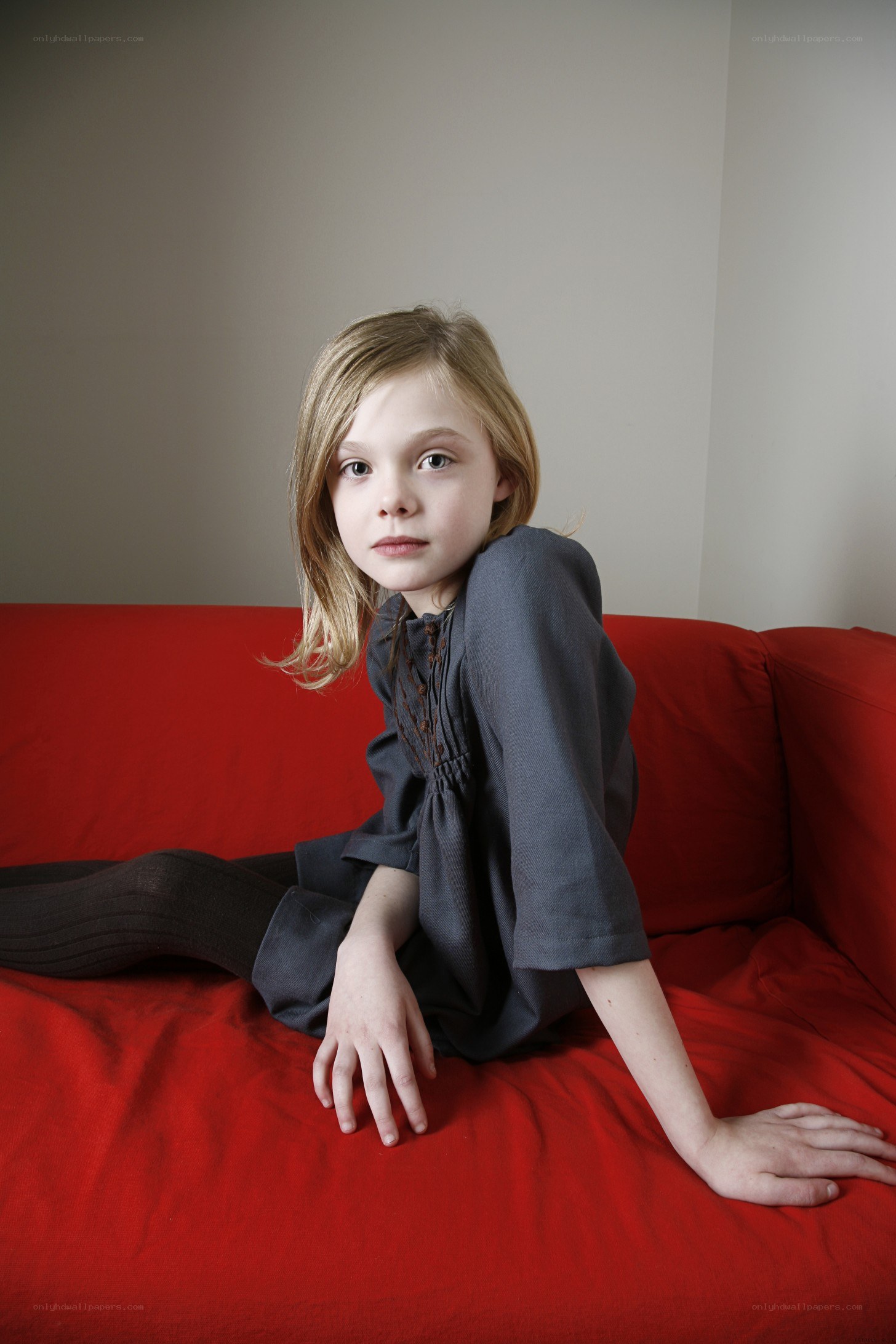 girl sitting on red couch