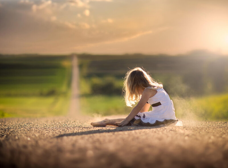 Girl Sitting on Road