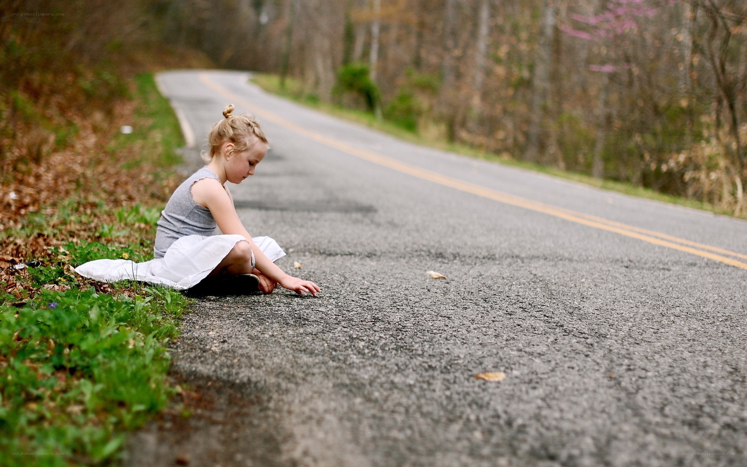 girl sitting on roadside
