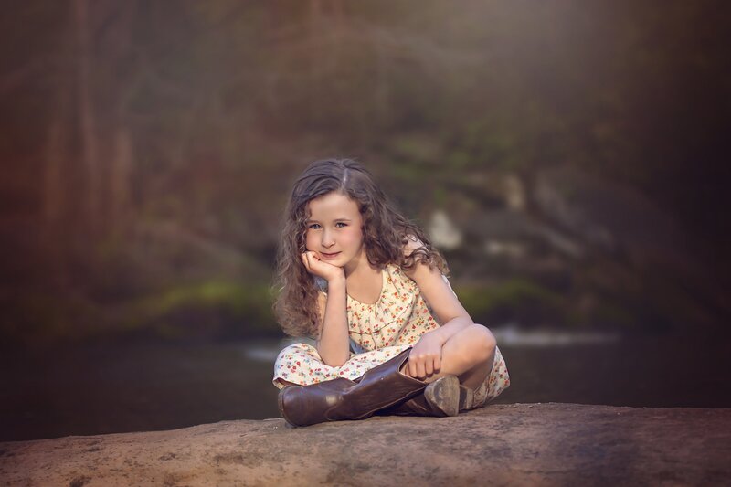 Girl Sitting on Rock — Brown