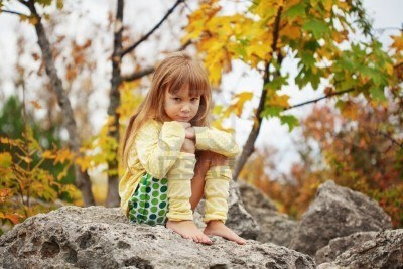 Girl Sitting on Rock — Yellow