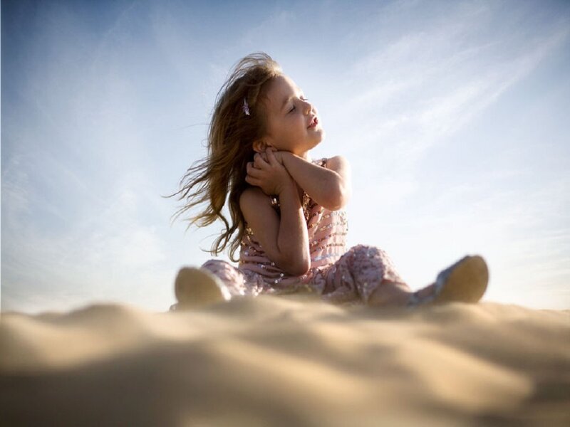 Girl Sitting on Sand — Blue