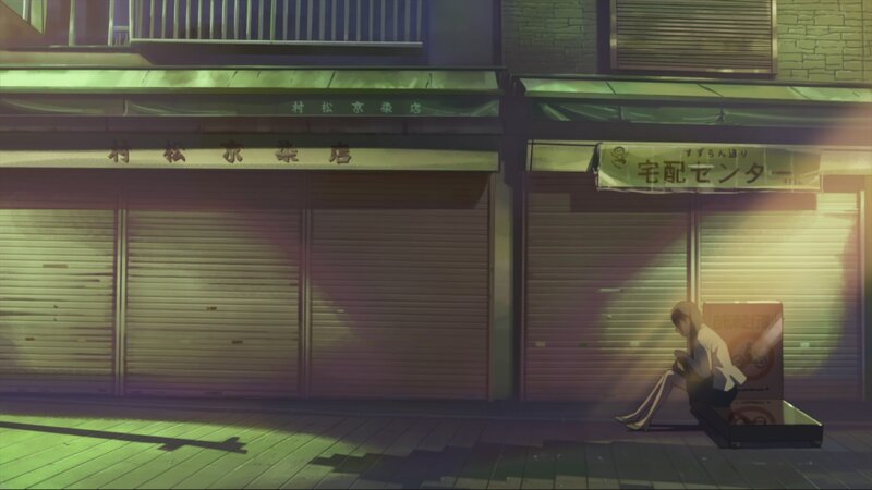 Girl sitting on sidewalk at night