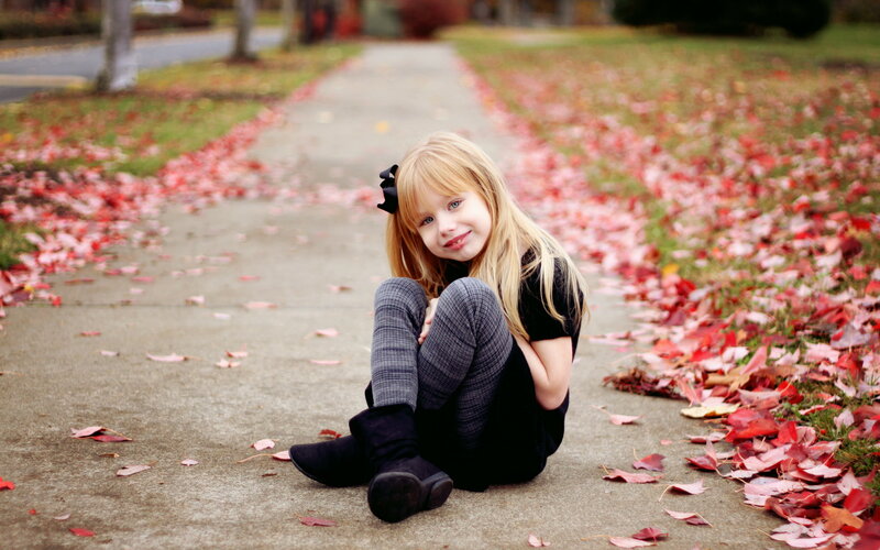 Girl Sitting on Sidewalk — Red