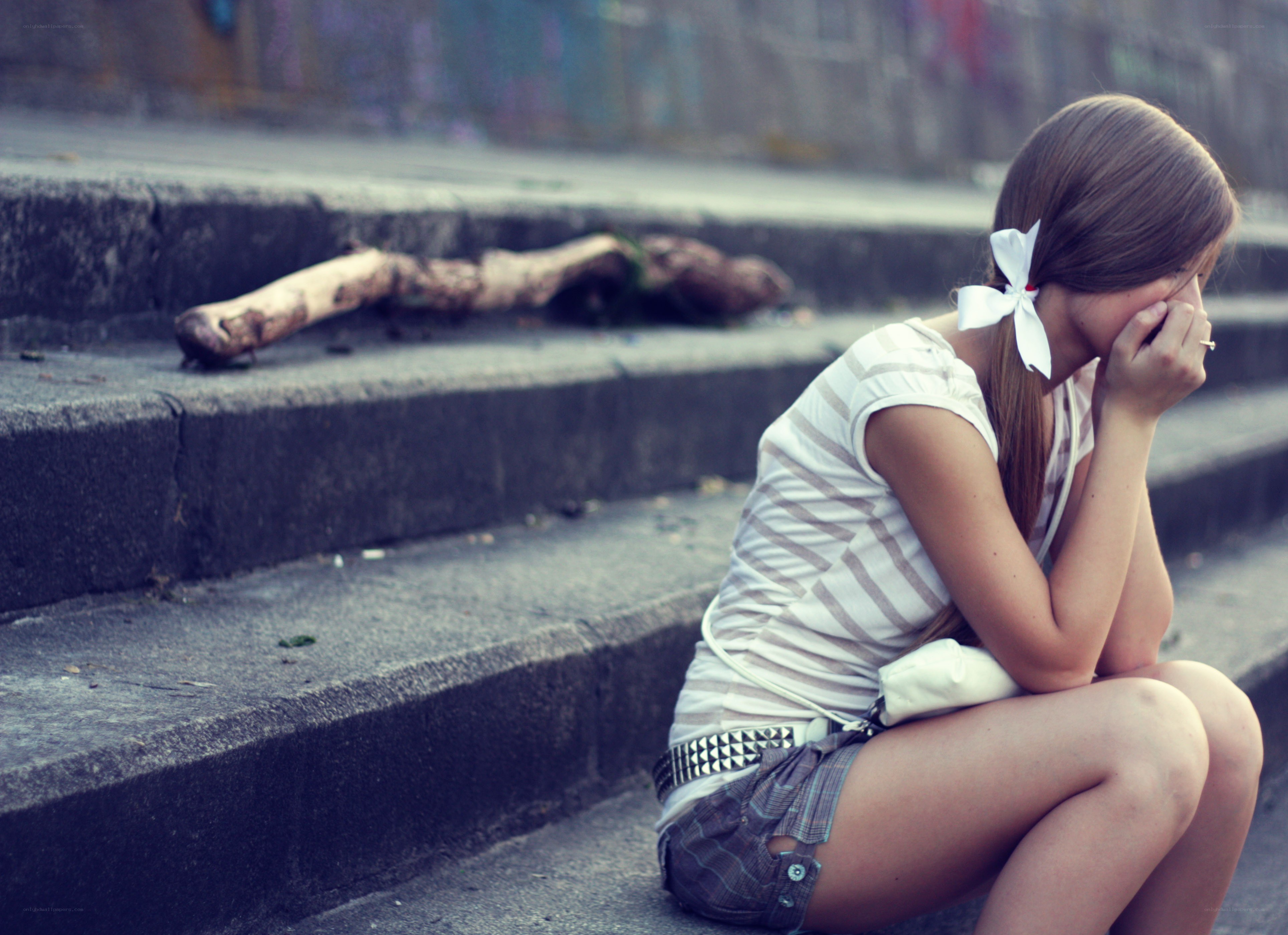 girl sitting on steps crying