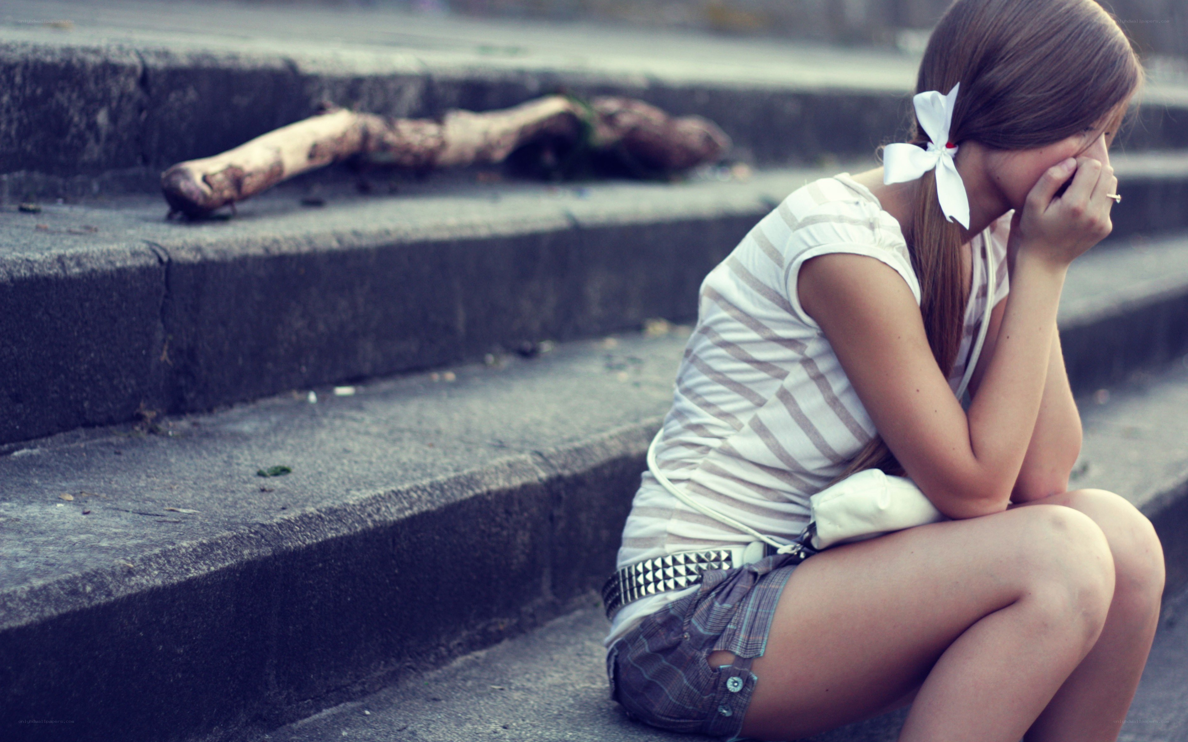 girl sitting on steps crying