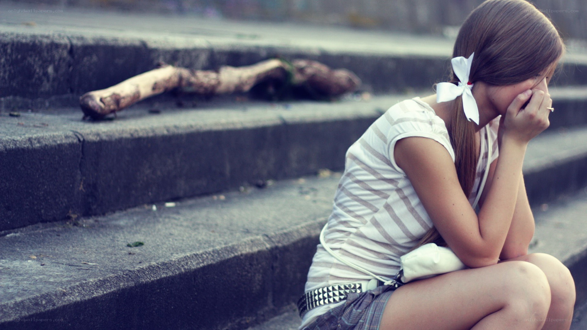 girl sitting on steps crying