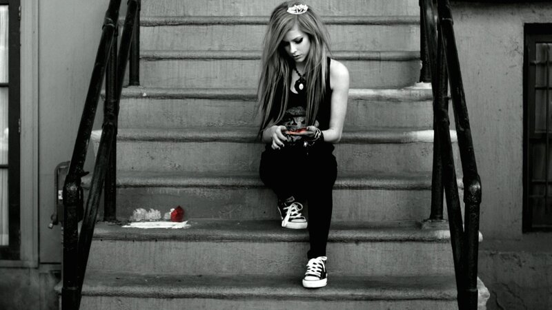 girl sitting on steps with phone