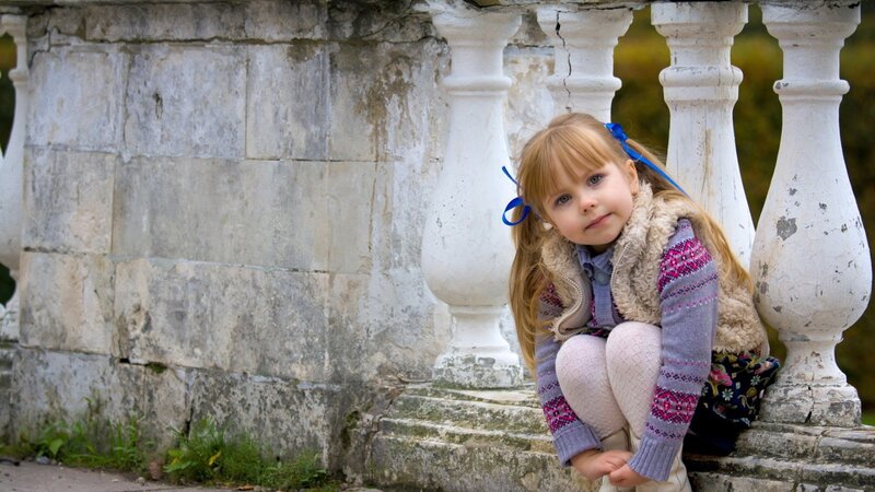 Girl sitting on stone steps