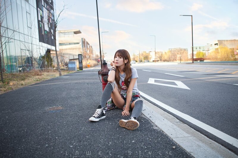 Girl sitting on street curb