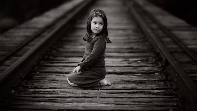 Girl Sitting on Train Tracks — Black
