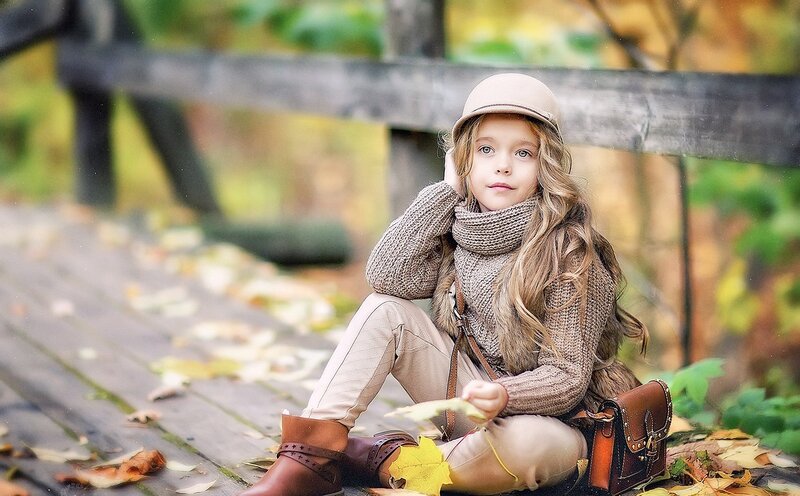 Girl Sitting on Wooden Deck
