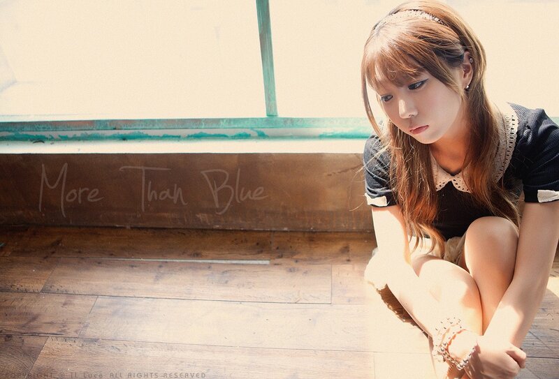 girl sitting on wooden floor