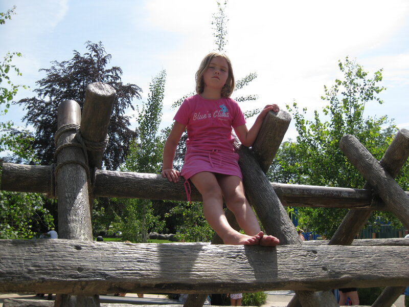 Girl Sitting on Wooden Structure