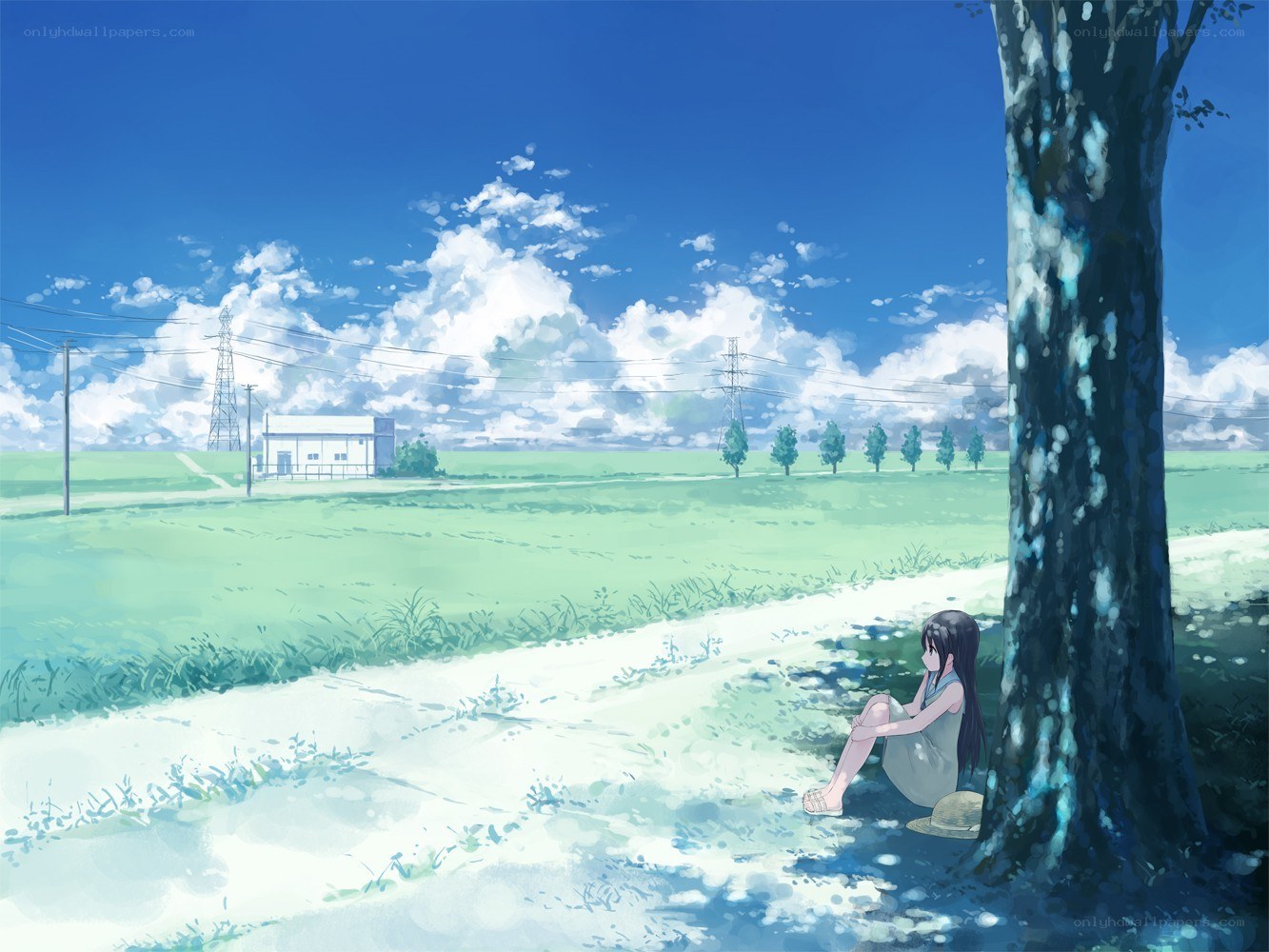 Girl sitting under a tree