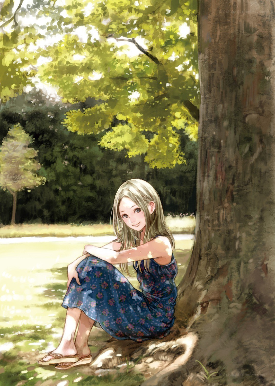 Girl sitting under a tree