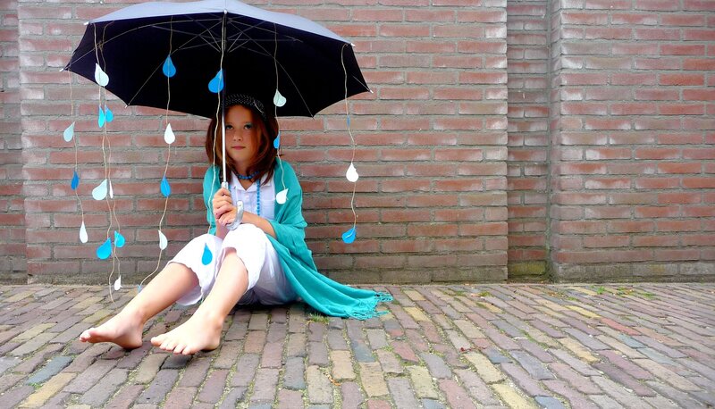 Girl Sitting under Umbrella