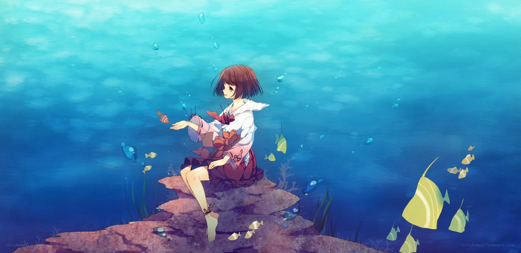 girl sitting underwater with fish