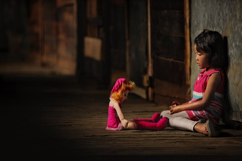 Girl Sitting with Doll