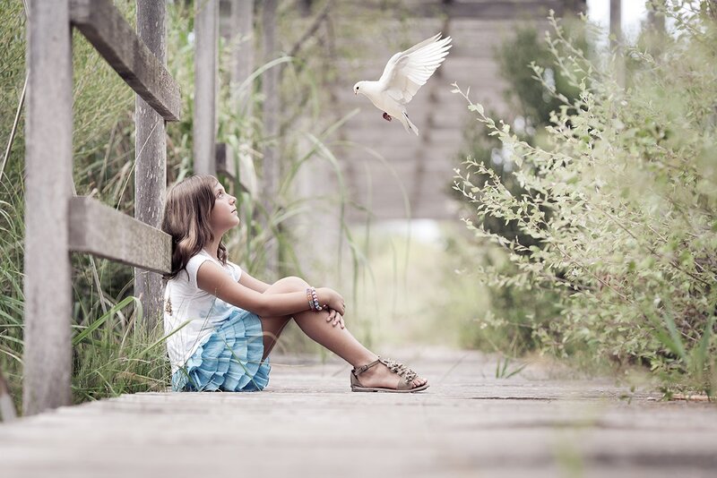 Girl Sitting with Dove