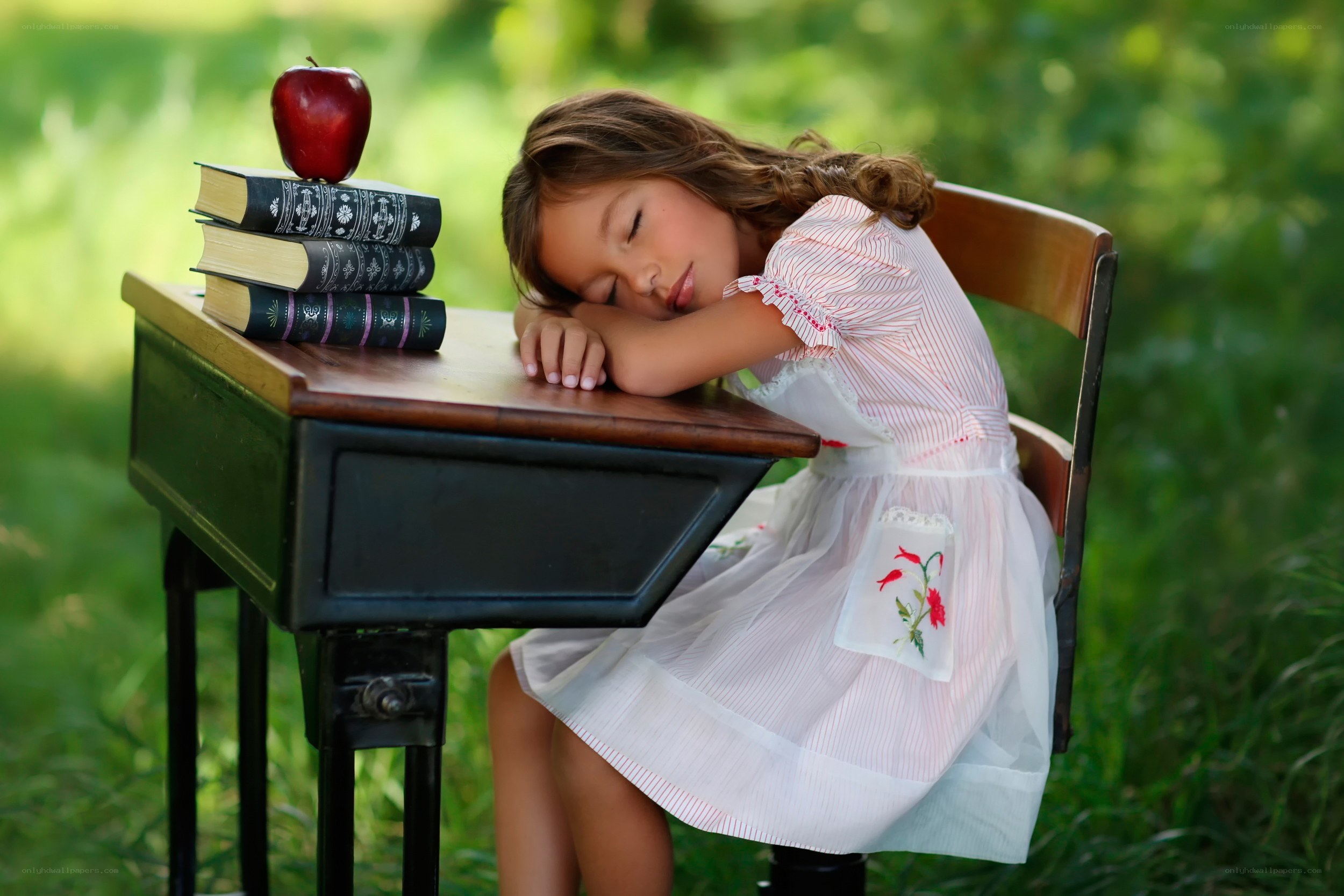 Girl sleeping at school desk