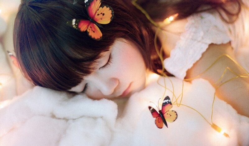 Girl sleeping with butterflies