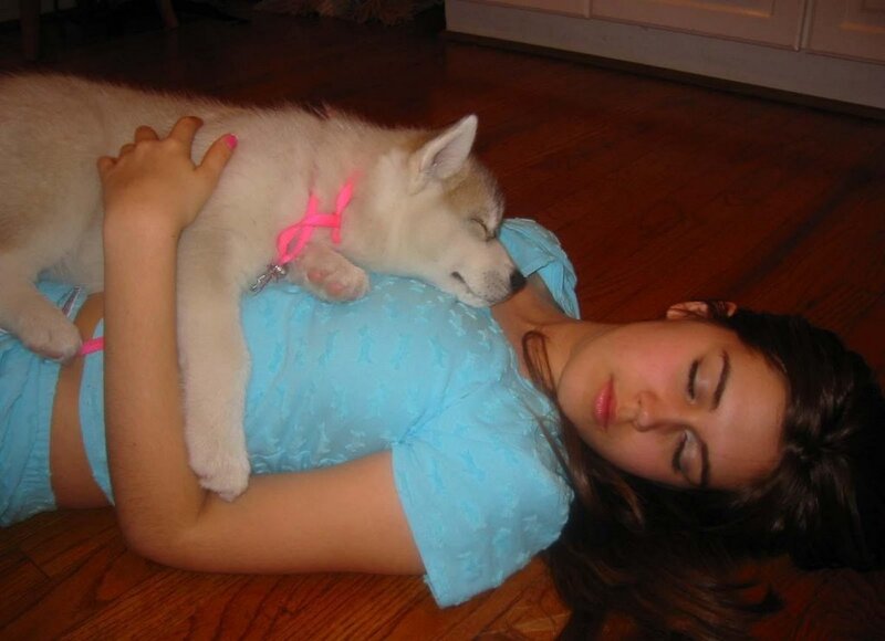 Girl sleeping with puppy
