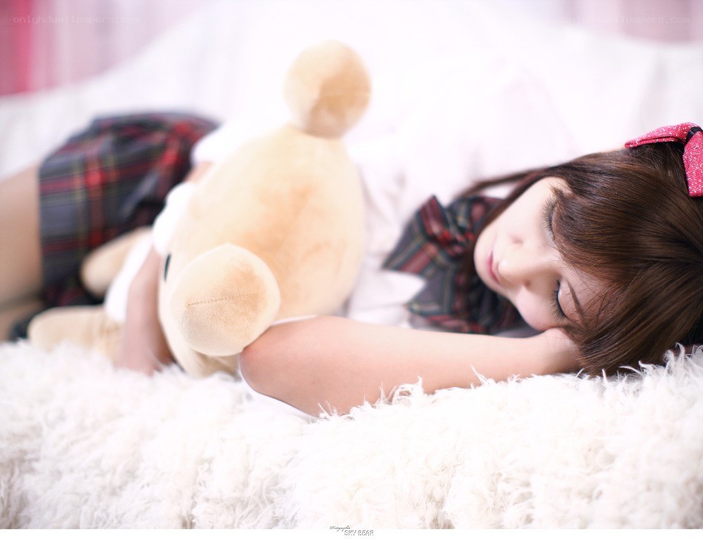 Girl sleeping with teddy bear