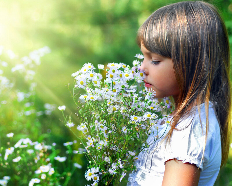 Girl Smelling Daisies