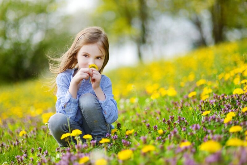 Girl Smelling Dandelion