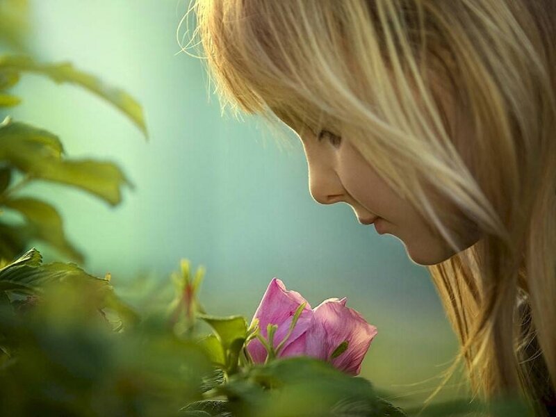 Girl Smelling Flower