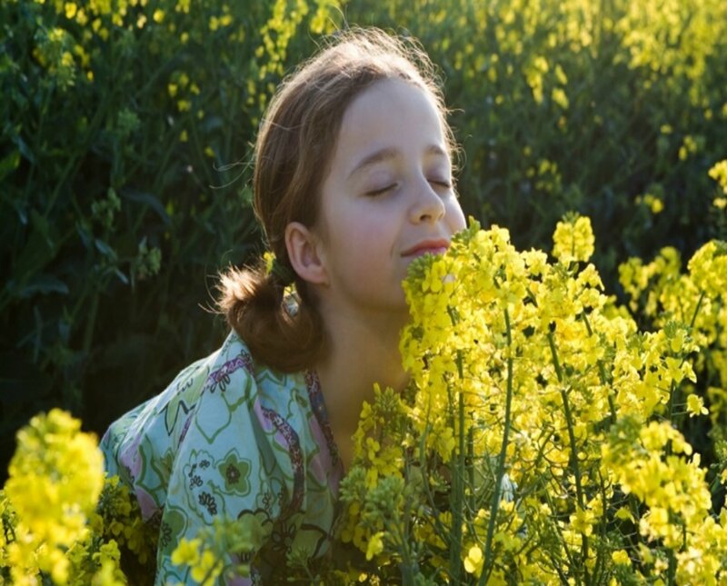 Girl Smelling Flowers — Yellow, Serene