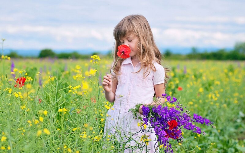 Girl Smelling Poppy Flower