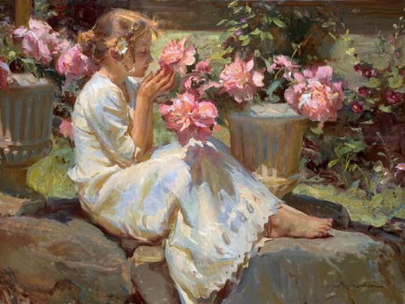 Girl smelling roses in garden