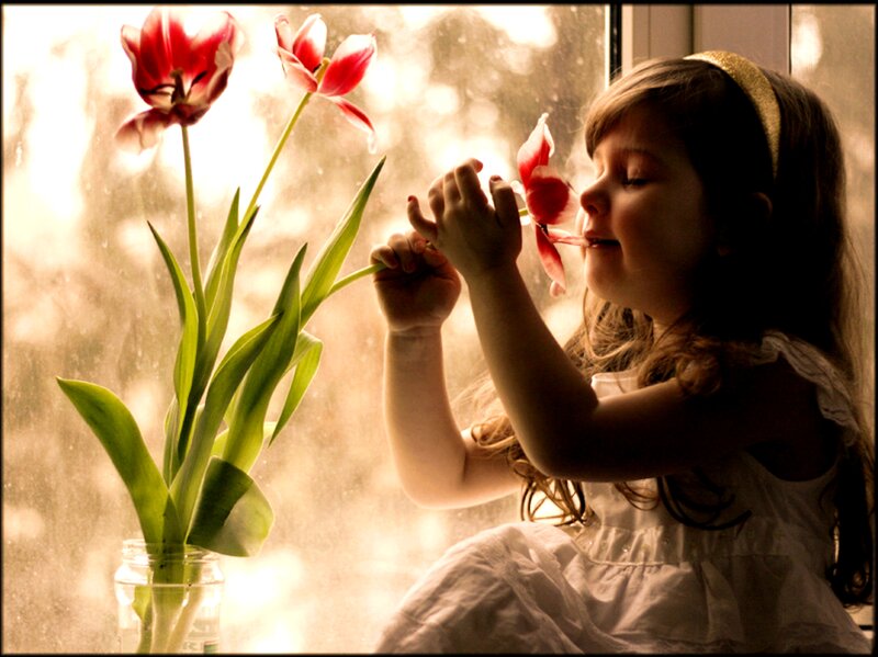 Girl Smelling Tulip