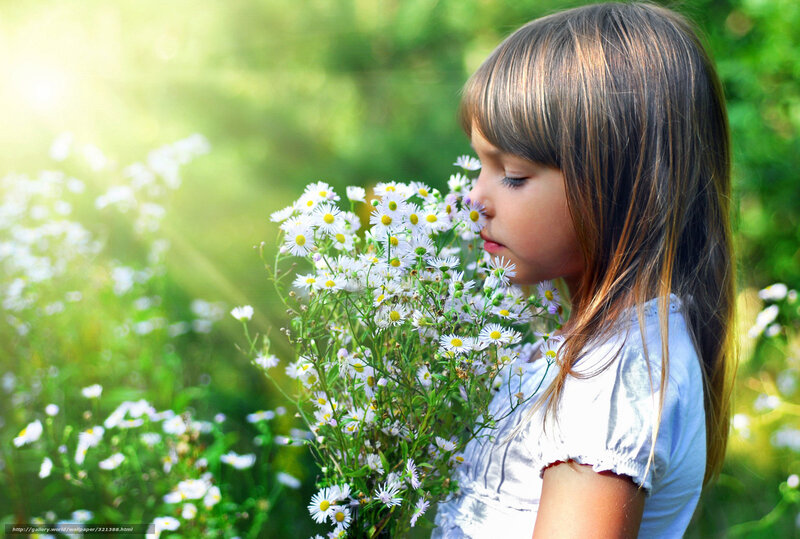 girl smelling wildflowers