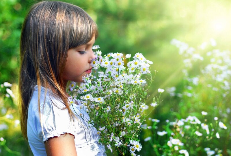 girl smelling wildflowers
