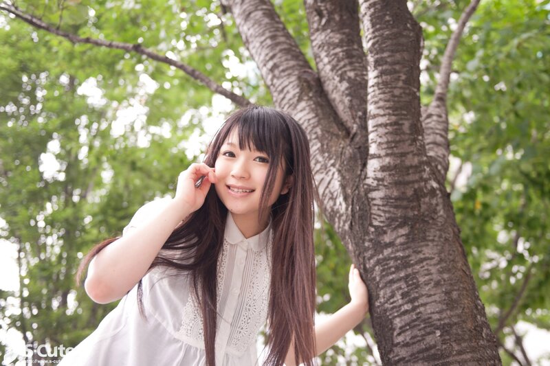 Girl smiling by a tree